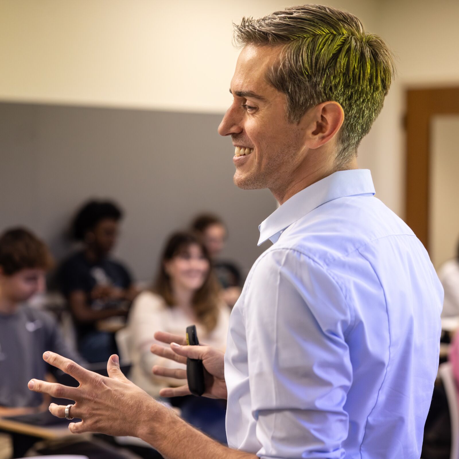 a professor gestures in front of a classroom